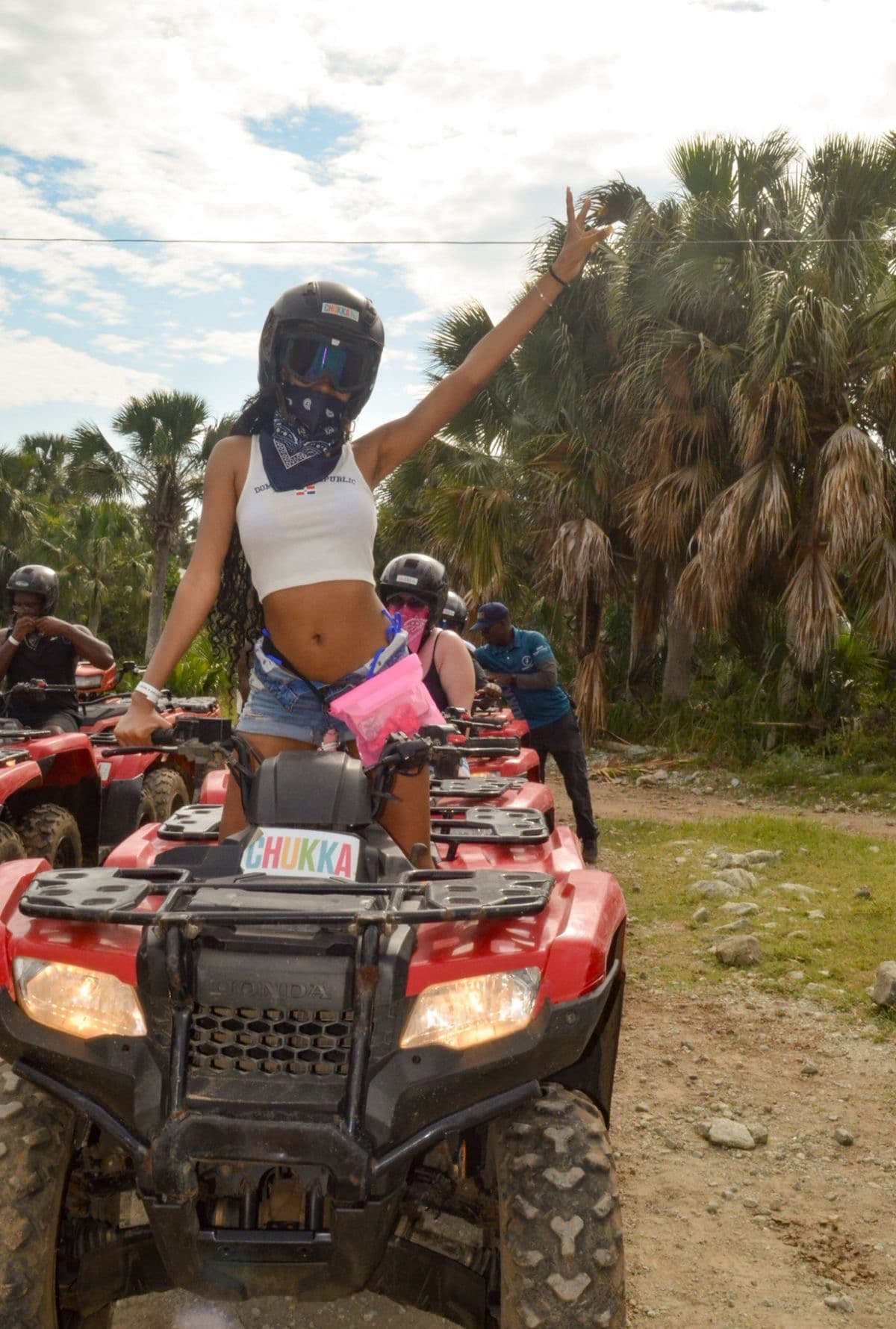 ATV rider on a palm-lined trail