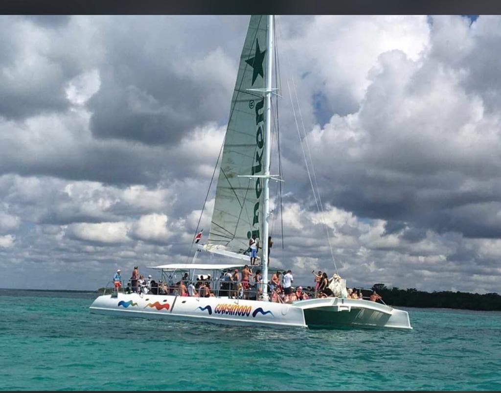 Party boat Punta Cana catamaran with travelers on turquoise water